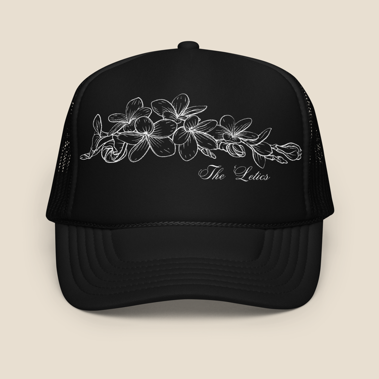 Black foam trucker hat with embroidered Champei or also known as Plumeria flower, front view.